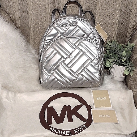 Michael Kors Handbags - NWT Michael Kors Abbey Silver Backpack